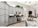 Beautiful kitchen featuring gray cabinets, granite countertops, stainless steel appliances, and views to other rooms at 621 W Desert Ave, Gilbert, AZ 85233