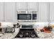 Modern kitchen with subway tile backsplash, stainless steel appliances, and granite countertops at 621 W Desert Ave, Gilbert, AZ 85233