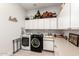 Laundry room with a washer and dryer, sink, and storage cabinets above the counter space at 621 W Desert Ave, Gilbert, AZ 85233
