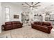 Living room with hardwood floors, large rug, a ceiling fan, and views into the kitchen and dining area at 621 W Desert Ave, Gilbert, AZ 85233