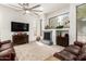 Cozy living room featuring a fireplace, hardwood floors, and comfortable seating with views to the outdoors at 621 W Desert Ave, Gilbert, AZ 85233