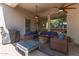 Covered patio featuring ceiling fans, a stone fire pit, comfortable seating, and a barbecue area for outdoor entertaining at 621 W Desert Ave, Gilbert, AZ 85233