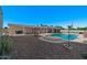 Expansive backyard featuring a pool, desert landscaping, and covered patio for outdoor living at 6602 E Heather Dr, Mesa, AZ 85215