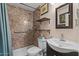 Updated bathroom features a shower, toilet, sink, mirror, and shelving for toiletries and décor at 6602 E Heather Dr, Mesa, AZ 85215