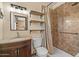 Functional bathroom featuring a sink, toilet, shower, and convenient shelving at 6602 E Heather Dr, Mesa, AZ 85215