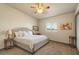 Comfortable bedroom featuring a ceiling fan, neutral walls, and a large window at 6602 E Heather Dr, Mesa, AZ 85215