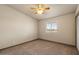 This bedroom offers a serene space with a ceiling fan and views of the desert landscape at 6602 E Heather Dr, Mesa, AZ 85215