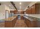 Well-appointed kitchen featuring stainless steel appliances, granite countertops, and custom cabinetry at 6602 E Heather Dr, Mesa, AZ 85215