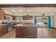 Updated kitchen boasts stainless steel appliances, granite countertops, island, and a view to the pool at 6602 E Heather Dr, Mesa, AZ 85215