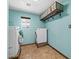 Bright laundry room featuring a washer, dryer, and shelving at 6602 E Heather Dr, Mesa, AZ 85215
