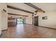 Spacious living area with tile floors, exposed beams, fan, large windows, and view to the backyard and pool at 6602 E Heather Dr, Mesa, AZ 85215