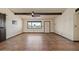 Spacious living area with tile floors, exposed beams, fan, and a large window with a view at 6602 E Heather Dr, Mesa, AZ 85215