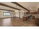 Open concept living area with beam ceilings, tile floor, and access to kitchen and other rooms at 6602 E Heather Dr, Mesa, AZ 85215