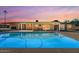 Inviting backyard oasis featuring a sparkling pool, covered patio, and outdoor living space for relaxation and entertainment at 6602 E Heather Dr, Mesa, AZ 85215