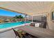Outdoor patio space with a luxurious pool and comfortable seating under a shaded pergola at 6602 E Heather Dr, Mesa, AZ 85215