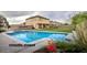 Large backyard with pool, covered patio, and privacy fence. Virtually staged at 703 N Redwood Ln, Buckeye, AZ 85326