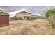 Expansive backyard with artificial grass, covered patio and ample space for landscaping and recreation at 703 N Redwood Ln, Buckeye, AZ 85326