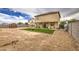 Large backyard with an artificial lawn, a shed, and plenty of space for activities at 703 N Redwood Ln, Buckeye, AZ 85326