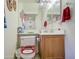 Cozy bathroom featuring tile flooring, a single sink vanity, and decorative accents at 703 N Redwood Ln, Buckeye, AZ 85326