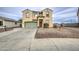 Two-story home showcasing a well-maintained front yard, and a green garage door at 703 N Redwood Ln, Buckeye, AZ 85326