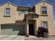 Charming two-story home featuring a quaint front door with a covered entryway and a well-maintained front yard at 703 N Redwood Ln, Buckeye, AZ 85326