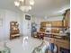 Traditional eat-in kitchen with wood cabinets, neutral countertops, tile floor and standard appliances at 703 N Redwood Ln, Buckeye, AZ 85326