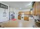 Open kitchen with stainless steel appliances, light oak cabinets, and an island at 703 N Redwood Ln, Buckeye, AZ 85326