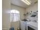Laundry room featuring white washer and dryer units with additional storage space at 703 N Redwood Ln, Buckeye, AZ 85326