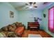 Cozy living room with comfortable seating, hardwood floors and a lovely piano at 703 N Redwood Ln, Buckeye, AZ 85326