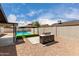 Backyard with gravel, a pool, a gazebo, and a custom grill with a marble-look base at 7232 W Sunnyside Dr, Peoria, AZ 85345