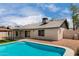 Backyard featuring a private pool, low-maintenance landscaping, and a covered patio for outdoor enjoyment at 7232 W Sunnyside Dr, Peoria, AZ 85345