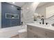 Modern bathroom offers a shower and tub combo, stylish vanity, and a round mirror for added elegance at 7232 W Sunnyside Dr, Peoria, AZ 85345