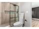 Contemporary bathroom showcasing walk-in shower, glass partition, toilet, and stylish wall decorations at 7232 W Sunnyside Dr, Peoria, AZ 85345