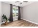 Bedroom with hardwood floors, natural light, and gray curtains, perfect for relaxation and comfort at 7232 W Sunnyside Dr, Peoria, AZ 85345