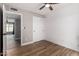 A bedroom featuring wood floors, a modern ceiling fan, and sliding closet door, maximizing space at 7232 W Sunnyside Dr, Peoria, AZ 85345