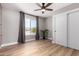 Bright bedroom with hardwood floors, ceiling fan, and sliding-door closet, offering a cozy retreat at 7232 W Sunnyside Dr, Peoria, AZ 85345