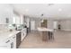 An open kitchen with white cabinets, stainless steel appliances, a central island, and modern design at 7232 W Sunnyside Dr, Peoria, AZ 85345