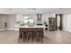 A modern kitchen with a large island and seating, white cabinets, stainless steel appliances, and open floor plan at 7232 W Sunnyside Dr, Peoria, AZ 85345