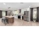 A modern kitchen featuring white cabinets, a spacious island, stainless steel appliances, and a view to the backyard at 7232 W Sunnyside Dr, Peoria, AZ 85345