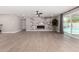 Open-concept living room featuring modern tile floors, marble fireplace, and sliding glass doors at 7232 W Sunnyside Dr, Peoria, AZ 85345