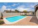 Sparkling pool surrounded by gravel, next to a covered patio and backyard gazebo on a sunny day at 7232 W Sunnyside Dr, Peoria, AZ 85345