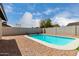 Backyard pool surrounded by gravel with views of the block wall and blue sky at 7232 W Sunnyside Dr, Peoria, AZ 85345