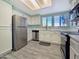 Well-lit kitchen features stainless appliances, white cabinets, and a large window at 750 E Northern Ave # 2088, Phoenix, AZ 85020
