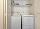 Convenient laundry room featuring a washer and dryer with shelving above at 750 E Northern Ave # 2088, Phoenix, AZ 85020