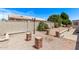 Private backyard with a desert landscape, block fencing, and a brick patio, offering a serene outdoor space at 7904 E Madero Ave, Mesa, AZ 85209