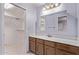 Well-lit bathroom with wood cabinets, mirror, and tile floor at 7904 E Madero Ave, Mesa, AZ 85209