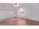 Bright bedroom with hardwood floors and a large window providing ample natural light at 7904 E Madero Ave, Mesa, AZ 85209