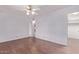 Bedroom features hardwood floors, a ceiling fan, and a walk-in closet for ample storage space at 7904 E Madero Ave, Mesa, AZ 85209