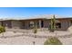 Charming single-story home featuring desert landscaping, gray brick accents and covered front entry at 7904 E Madero Ave, Mesa, AZ 85209