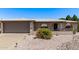 Charming single-story home featuring desert landscaping, gray brick accents and covered front entry at 7904 E Madero Ave, Mesa, AZ 85209